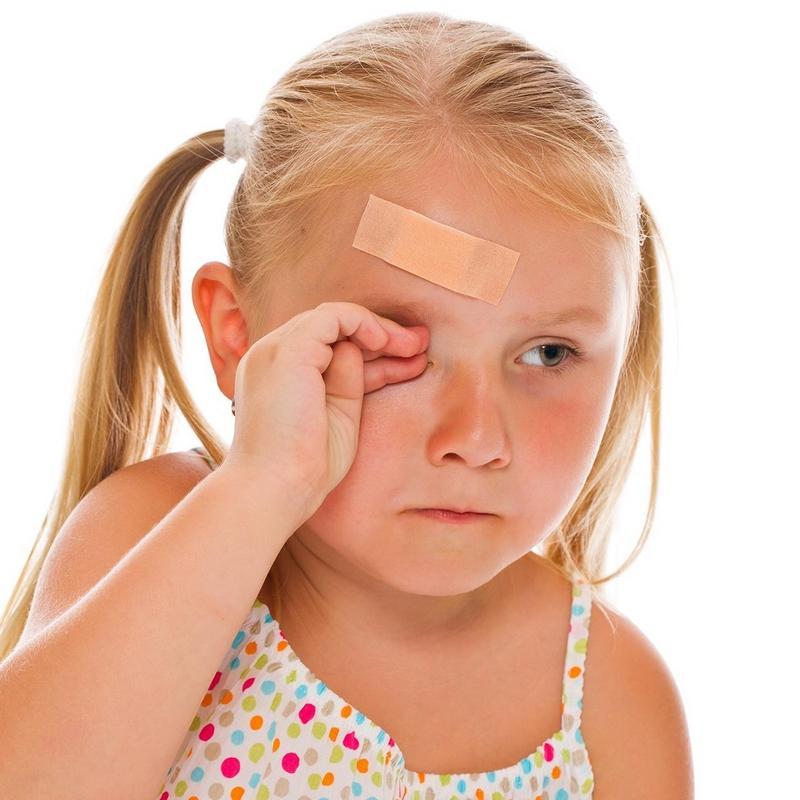 Small girl crying with a band-aid on her forehead